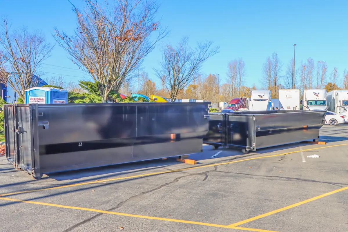 Professional dumpster rental service with roll-off container on residential driveway in Fairfield